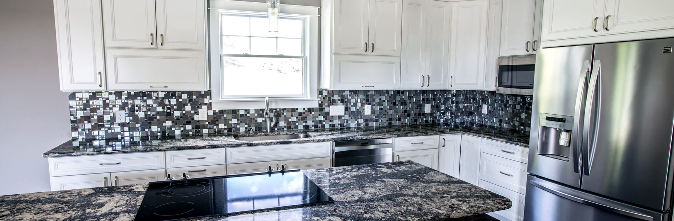 Custom Residential Kitchen featuring solid wood cabinets with a white finish, glass tile backsplash, stone countertops