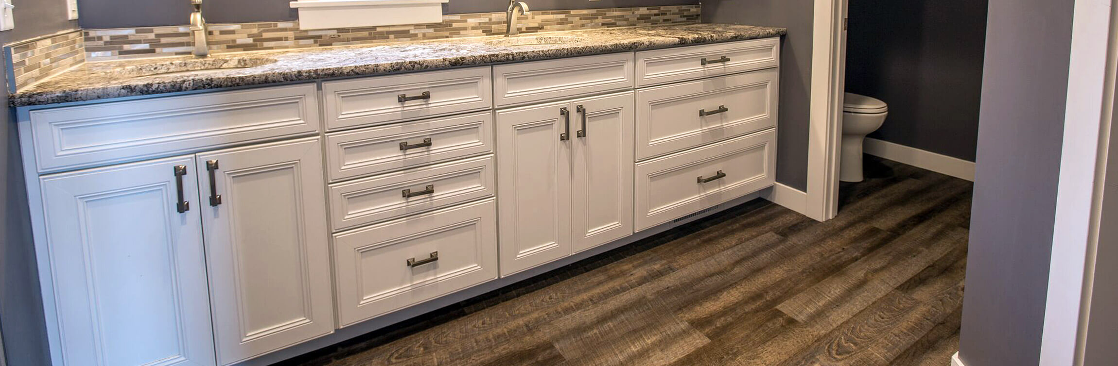 Custom Bath Vanity featuring solid wood cabinets with a white finish, glass tile backsplash, stone countertops